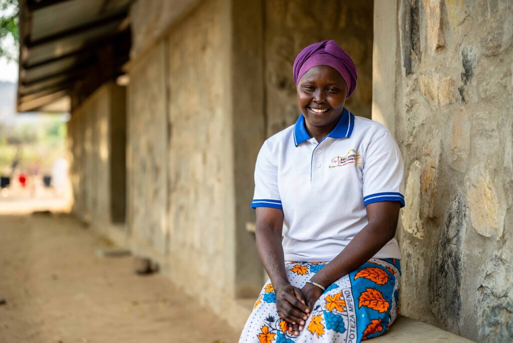 A young smiling female healthcare worker outside of a hospital