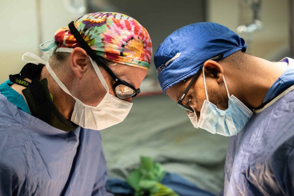 A close up of two surgeons operating