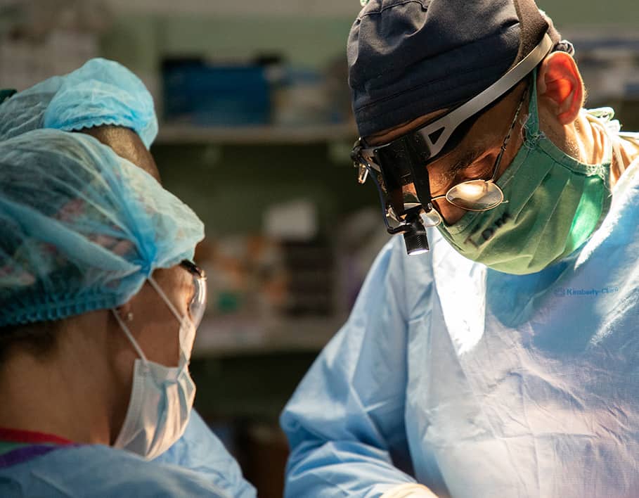 Doctors preforming surgery on patient.