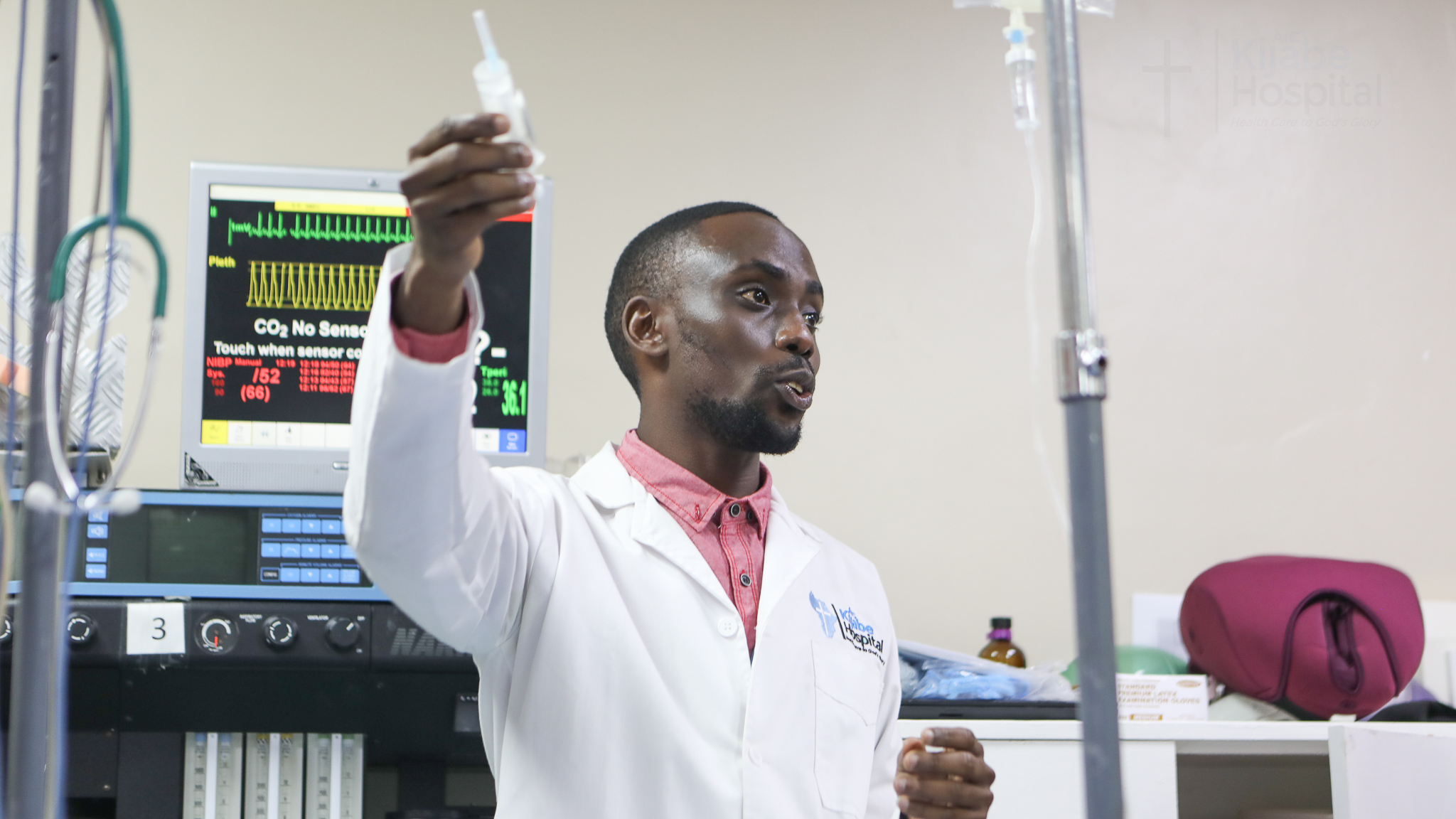 A young doctor explains something to a group of physicians (not pictured)