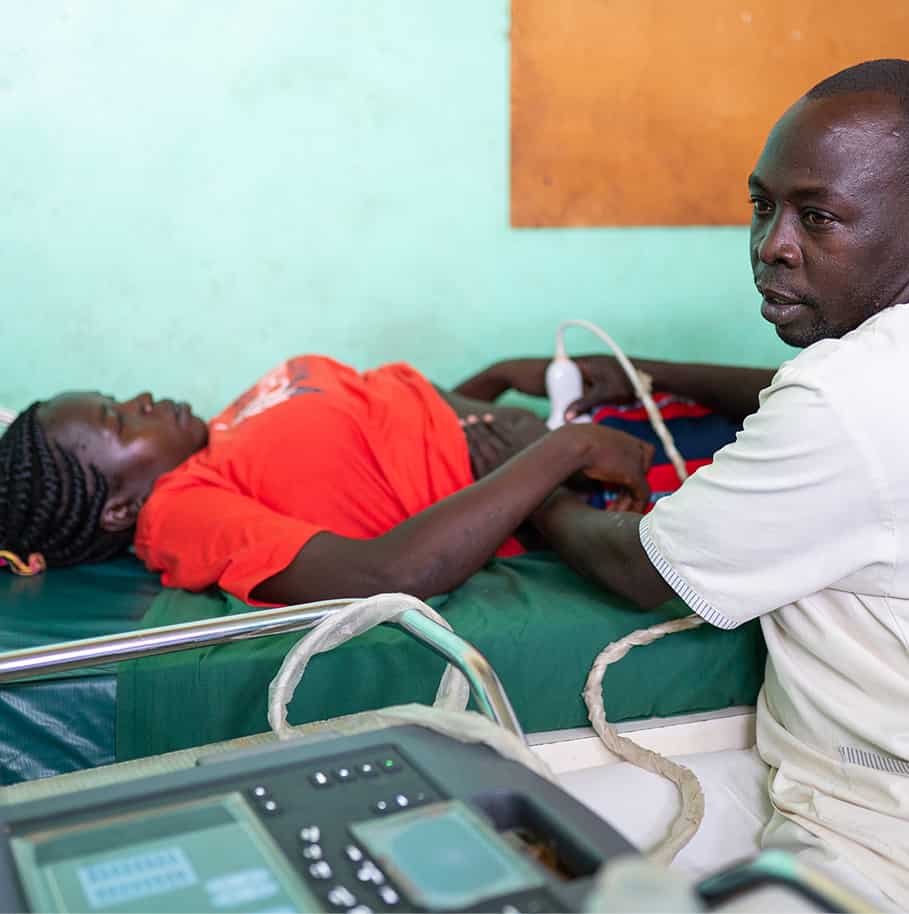 a doctor performing ultrasound on patient.