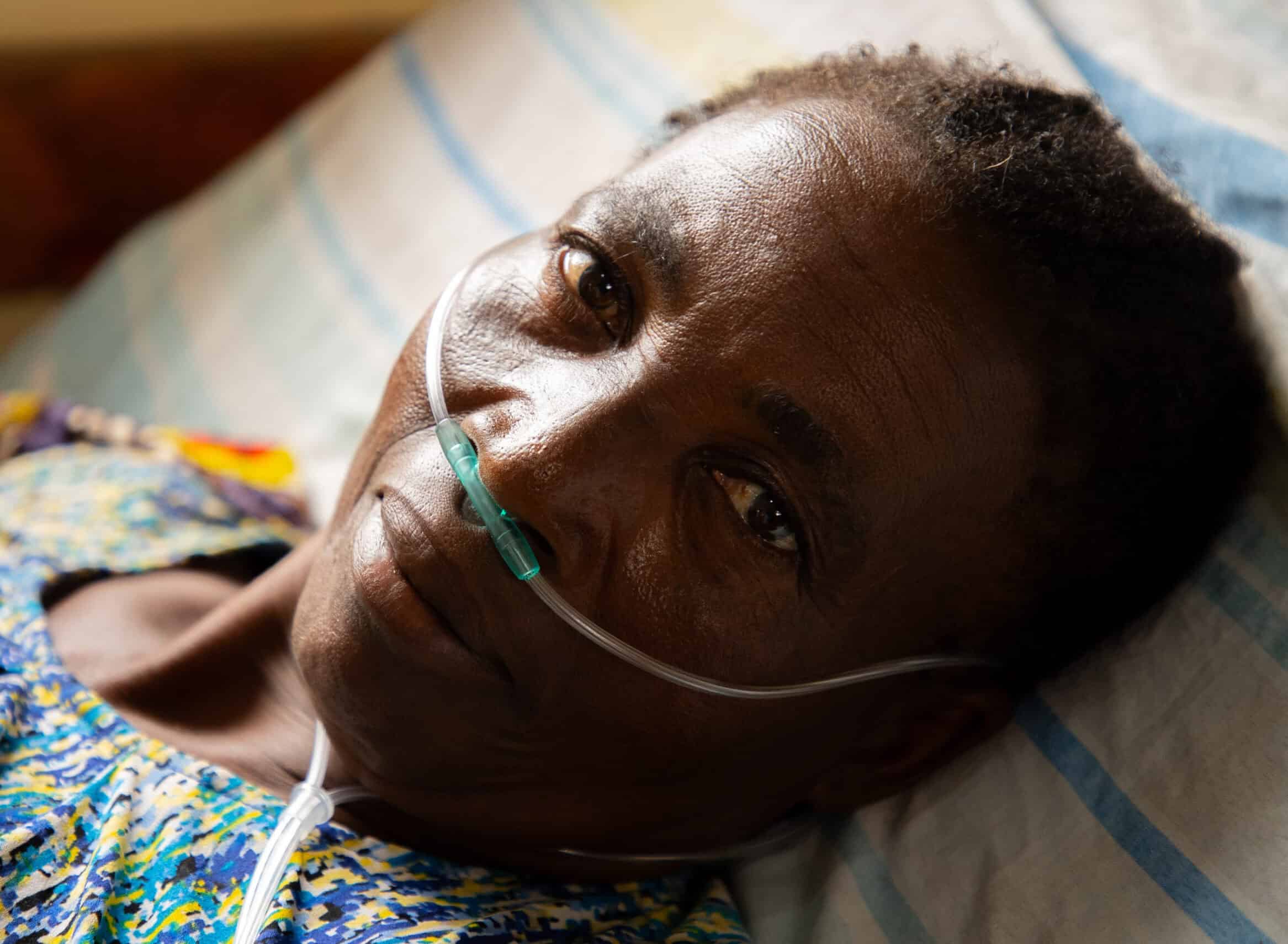 A close up of an older woman receiving oxygen