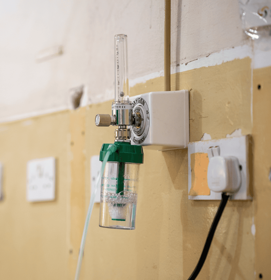 A small wall-mounted oxygen tank