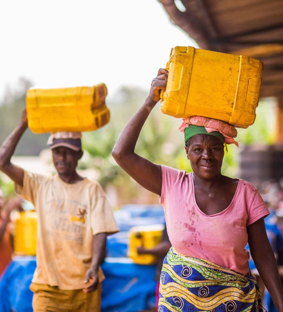 2 people carrying water