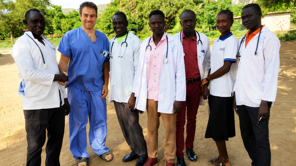 Dr. Gary Ulrich standing with members of the medical team in the Nuba Mountains