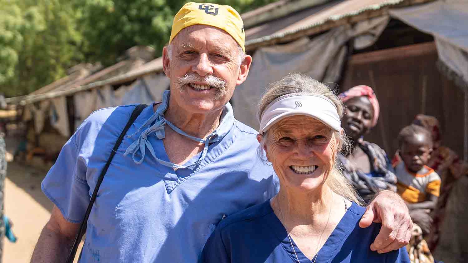Dr. Bill Rhodes and Laura Rhodes standing together in a hospital courtyard.